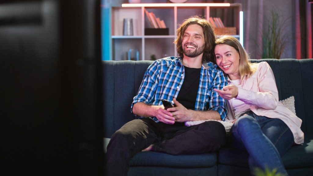 A couple watching movie in happy mood.