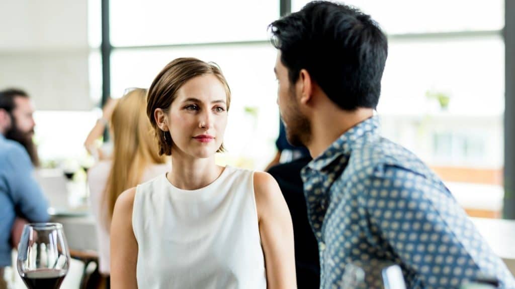 A woman looking at a man standing next to her.