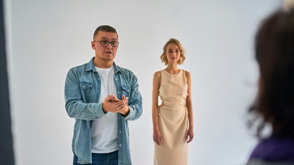 A man talking to a woman standing opposite to him.