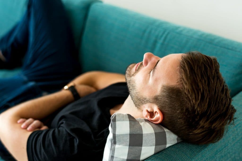 Man resting on a couch.