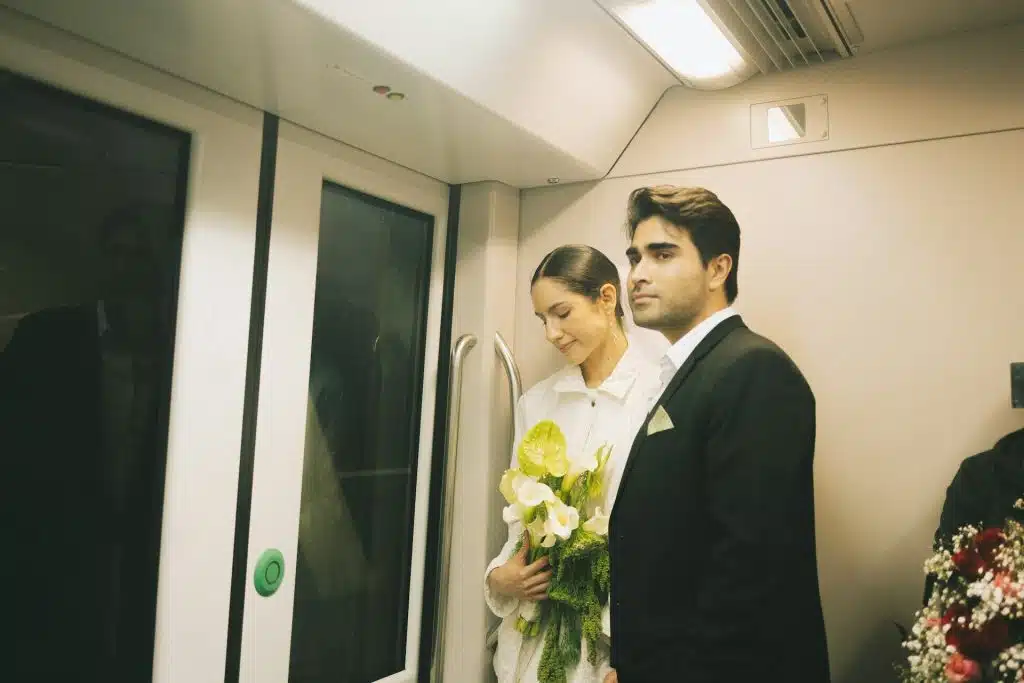 Women is standing gracefully side by a man