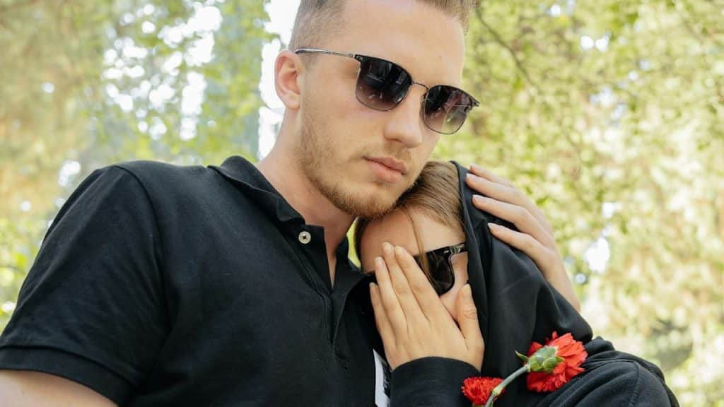 A women lying his head on the shoulders of a men