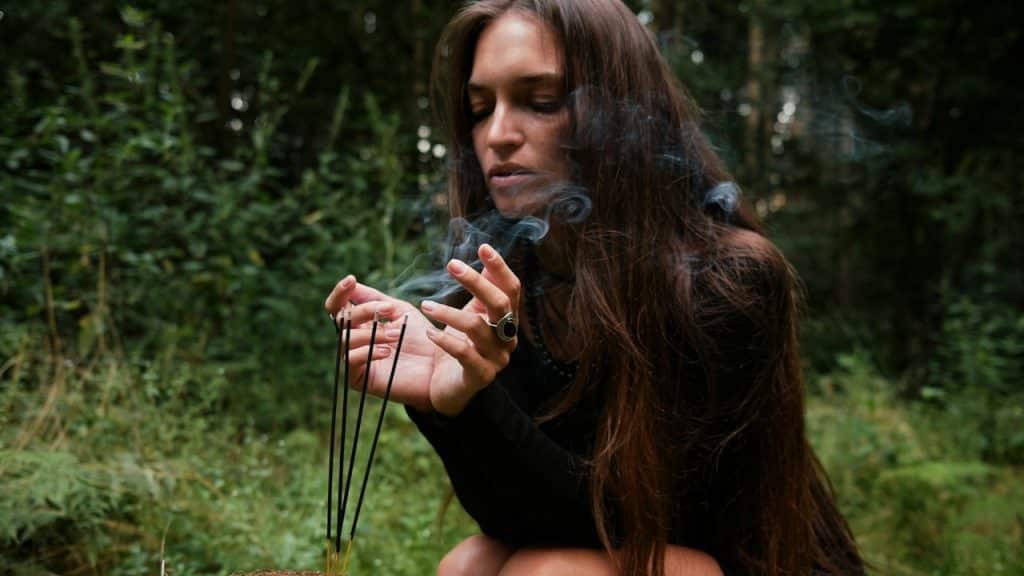 A women has light the sticks with smoke eveporating from it