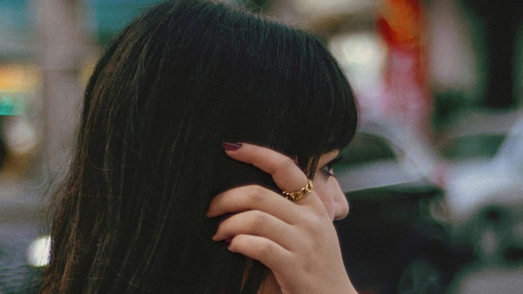 A woman adjusting her hair.