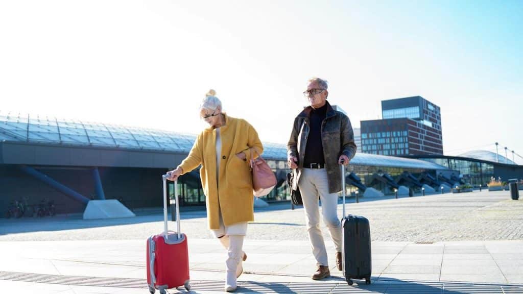 A couple walking in a railway station after traveling.