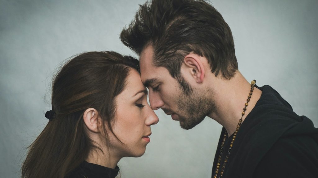 A couple touching foreheads and having a tender moment.