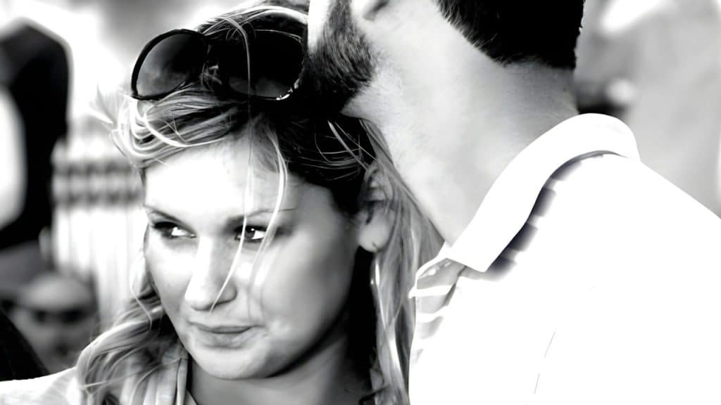A man embraces a woman standing near him.