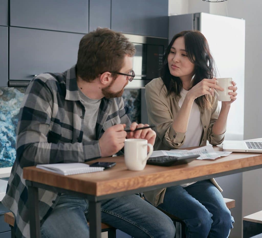 Woman happily planning future while man looks uncomfortable