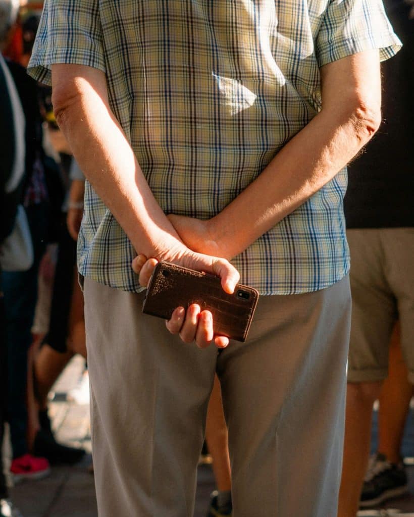 Man hiding his phone behind his back
