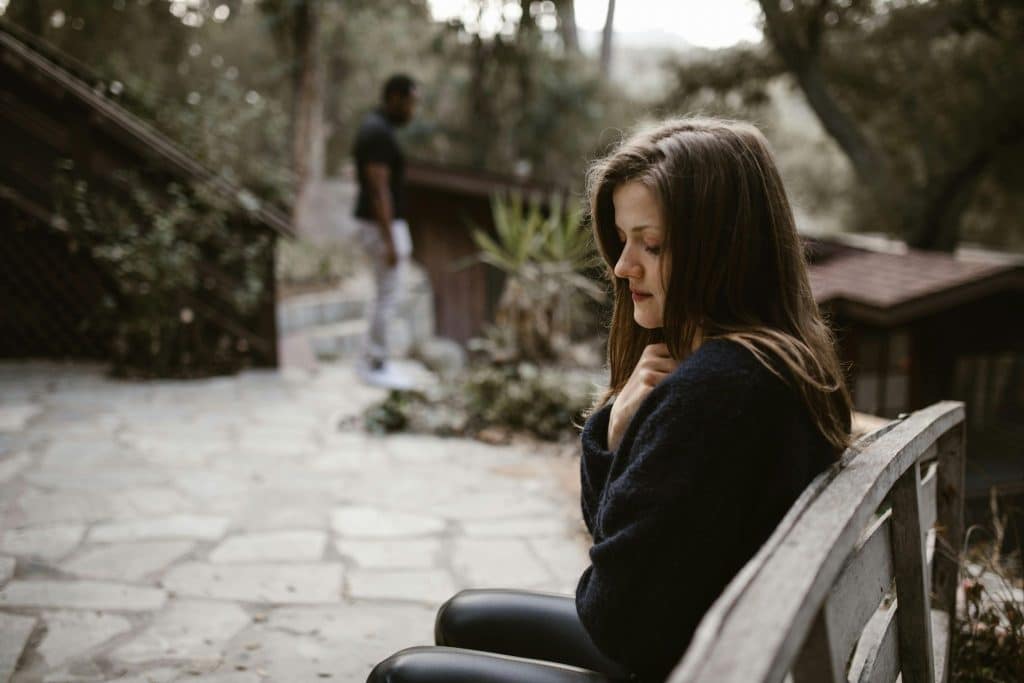 Man leaving woman on a bench