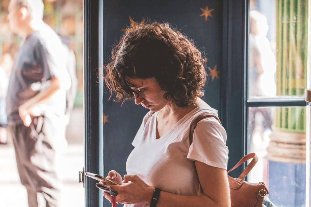 Woman hiding phone while texting secretly