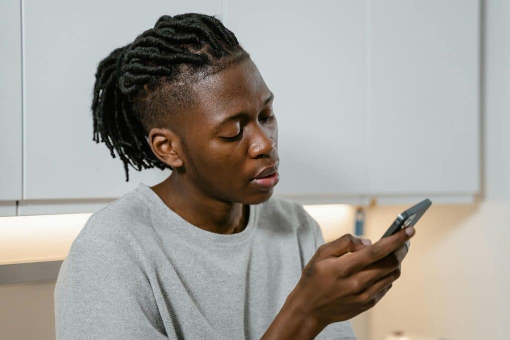 Man checking phone while messages go unanswered
