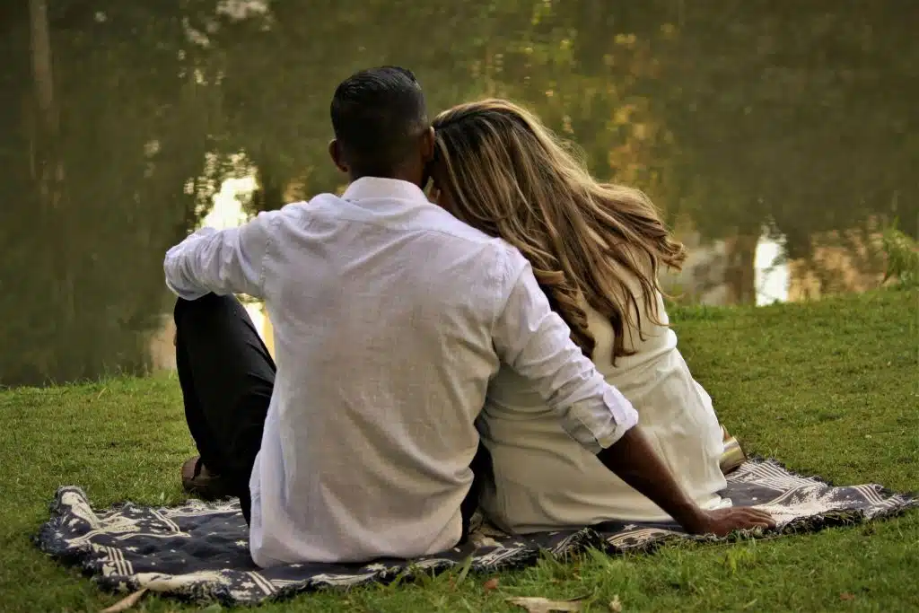 Couple sitting quietly together, reflecting on relationships and missed realizations