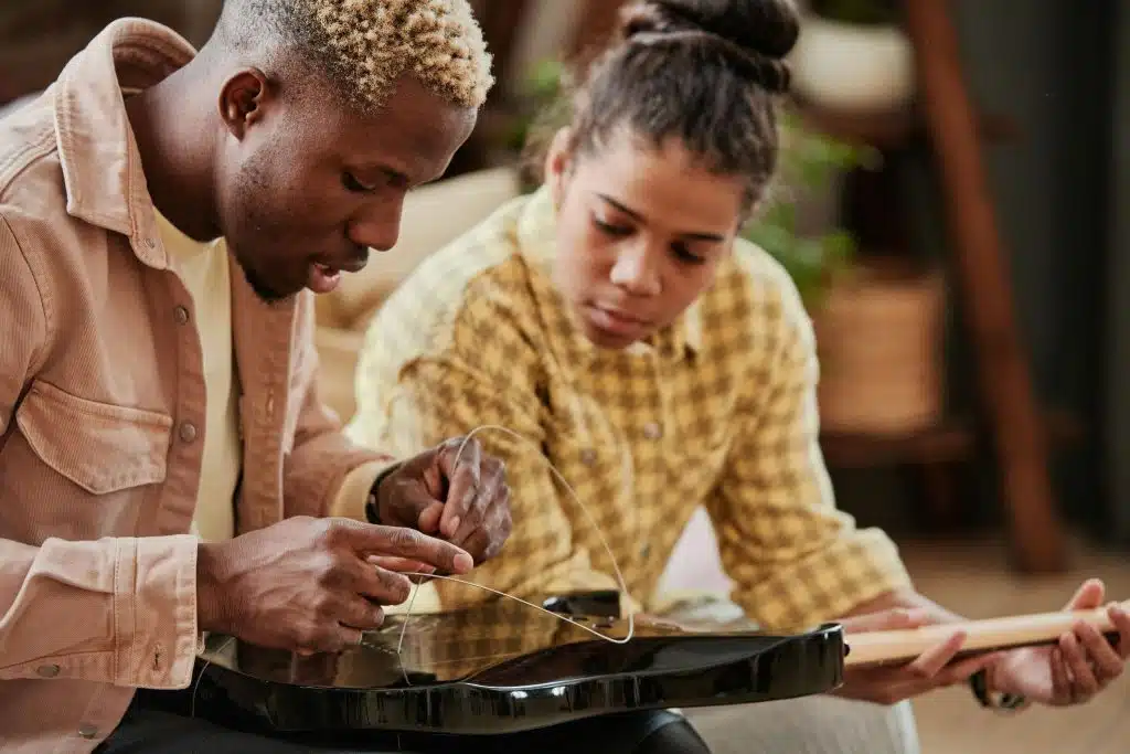 Man fixing something at home while partner watches