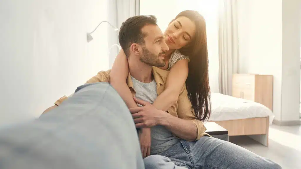 A man hugged by woman