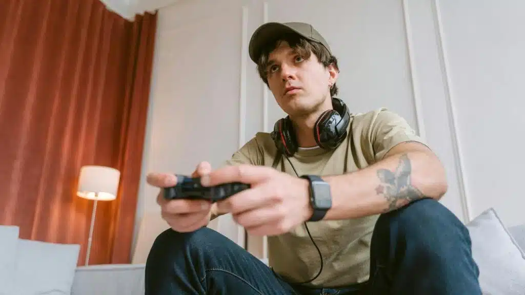 A young man playing a video game with a controller.