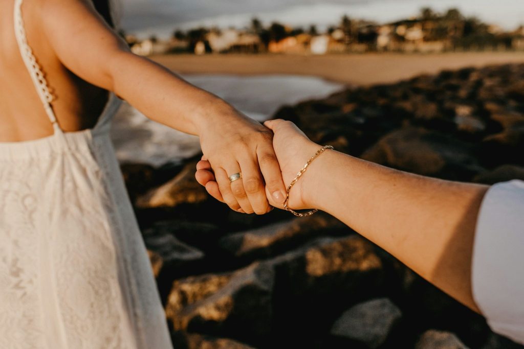 A man reaching a woman’s hand