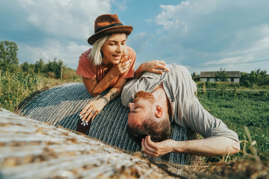 A man and woman being comfortable under the sun