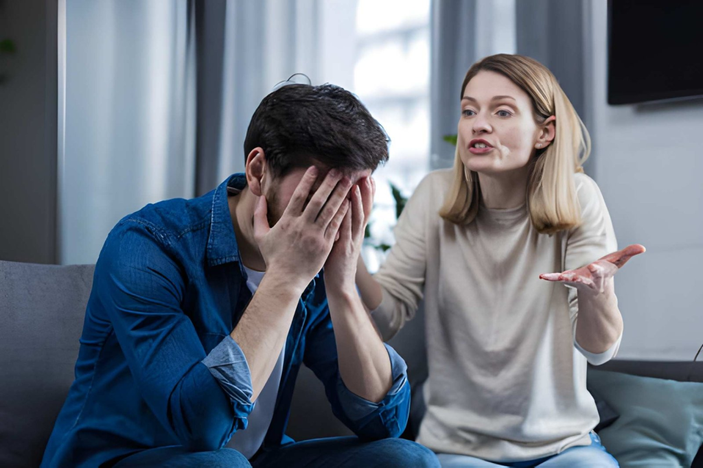 Man avoiding conflict from upset wife in living room