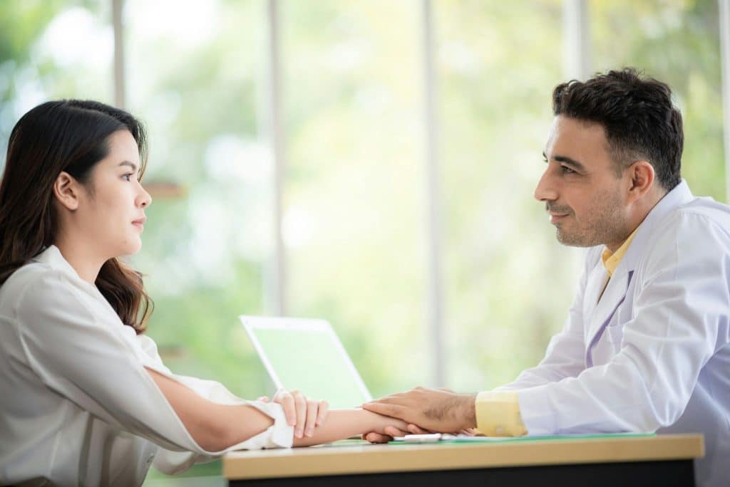 A man talking to a serious woman
