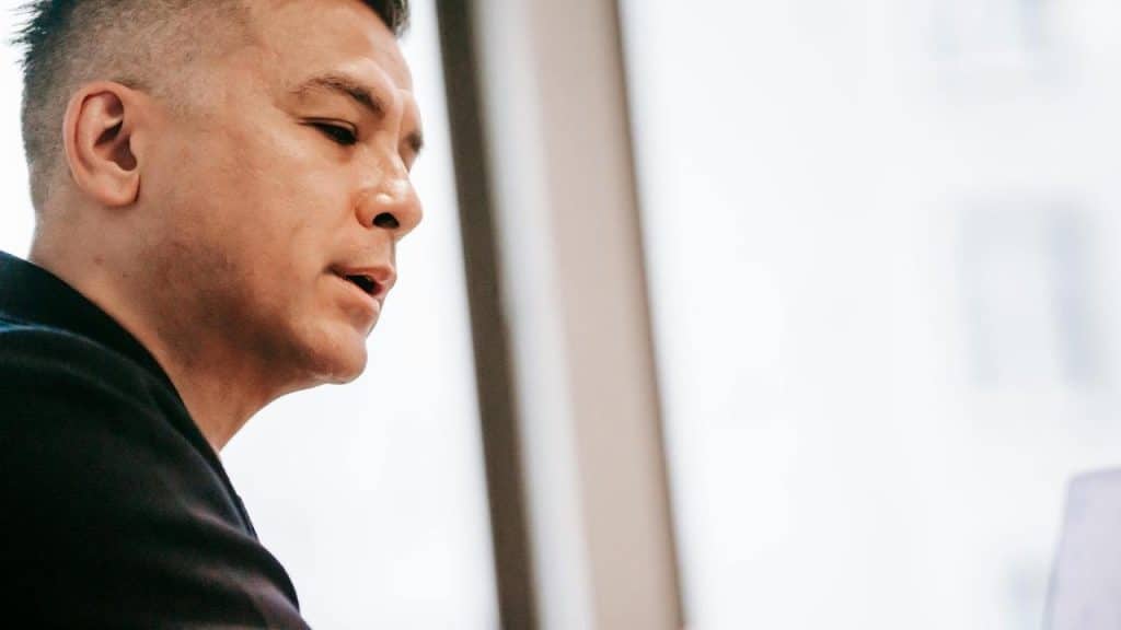 A man looking off to the side with a focused expression.