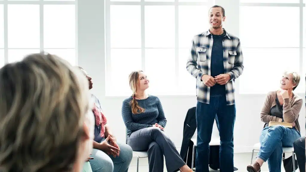 A man is presenting his ideas in front of his team.