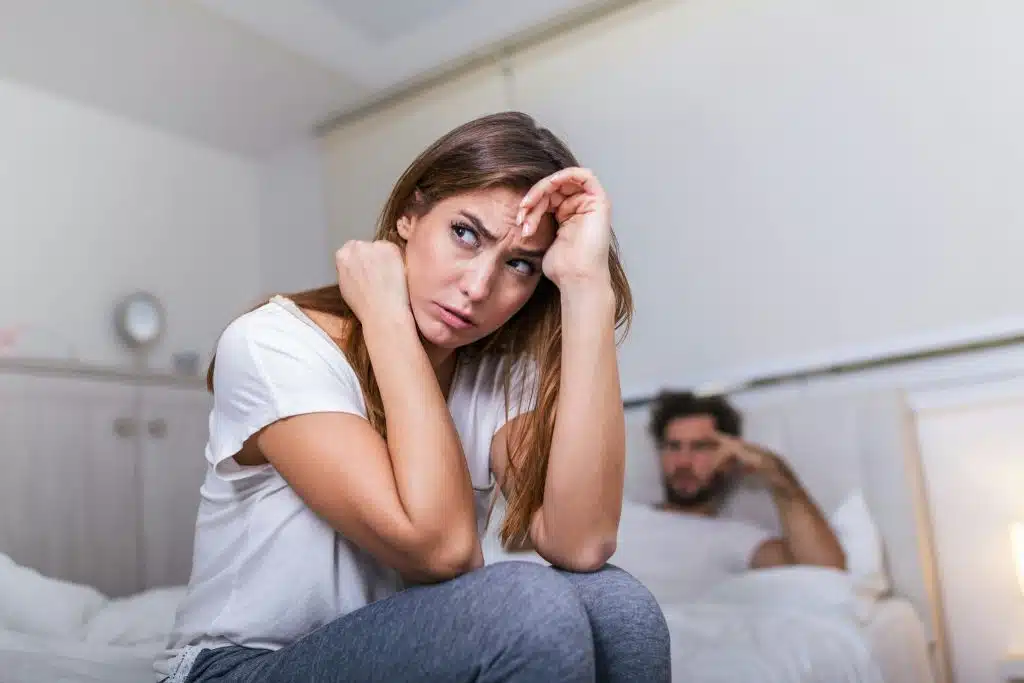 A man being silent behind the woman