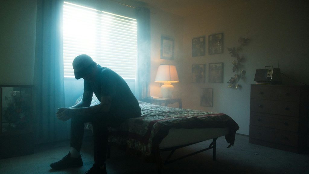 A man sitting on the bed