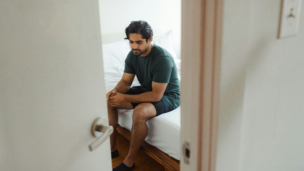 A man sitting on the bed