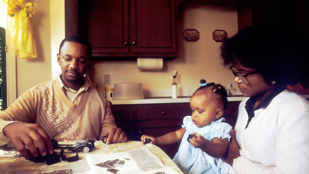 A man and woman with their child