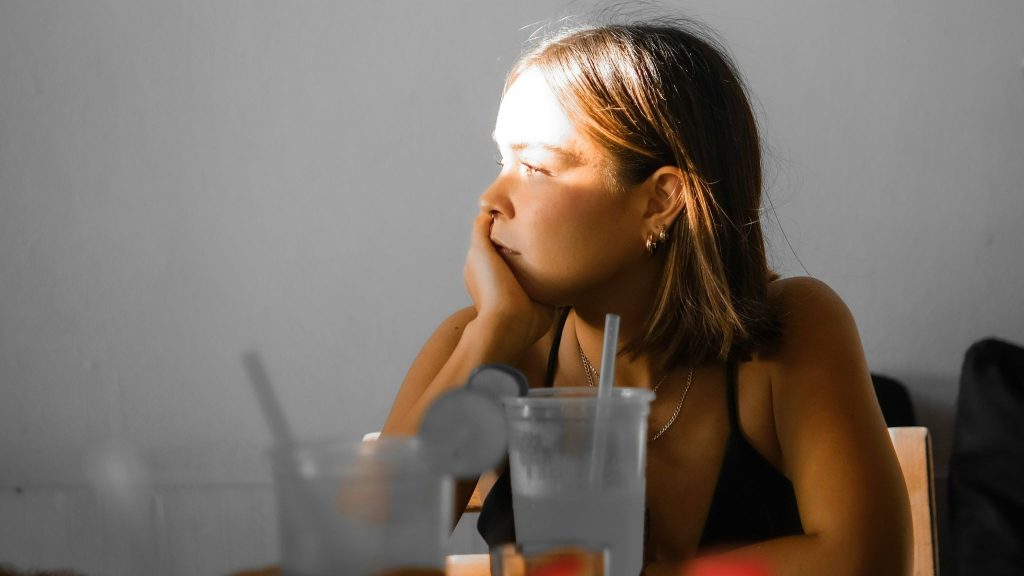 Woman thing and staring at nowhere