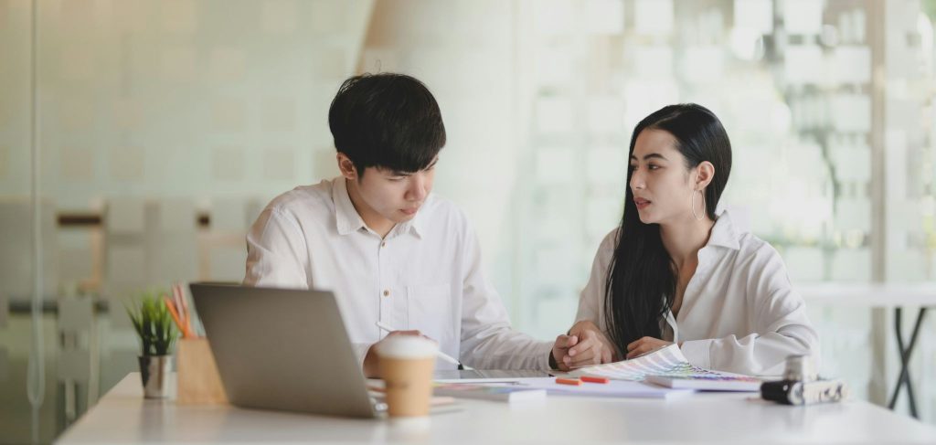 A man checking woman’s work