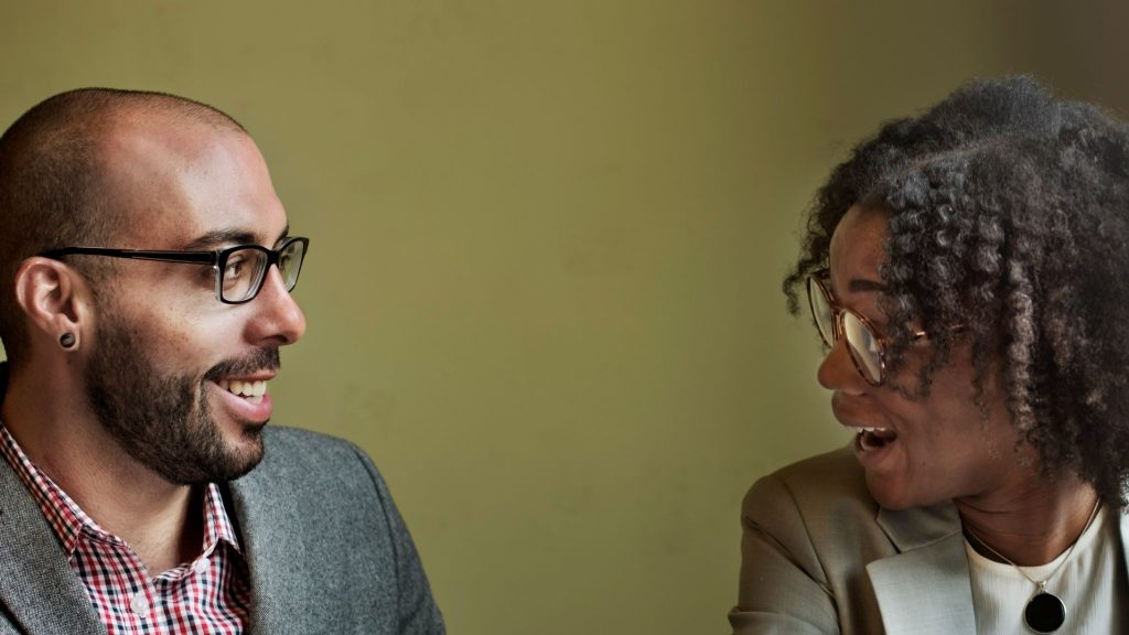 A man explaining something to woman