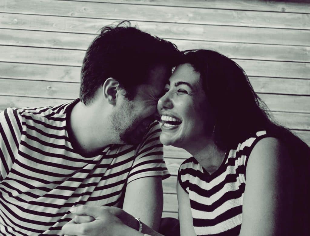 A man and woman hugging deeply.
