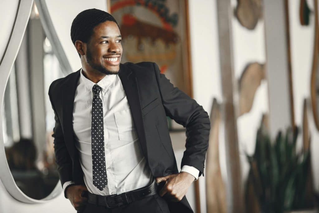 A man in a suit smiling.