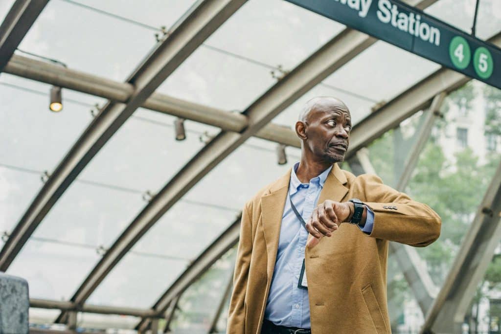 A man looking at his watch, waiting patiently.
