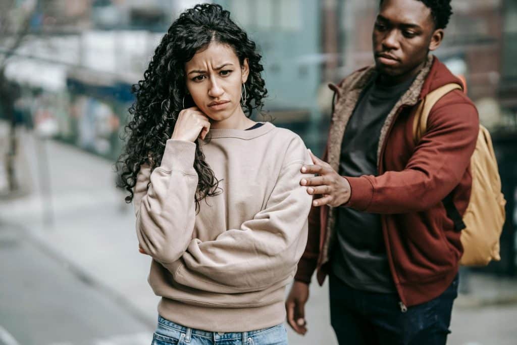 A couple arguing in the street.