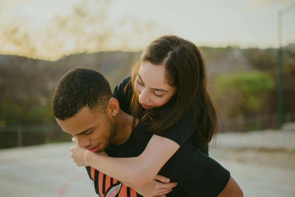 A man and woman hugging deeply.