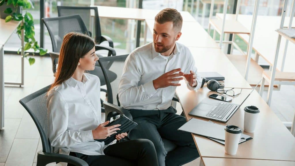 A man explaining something to woman