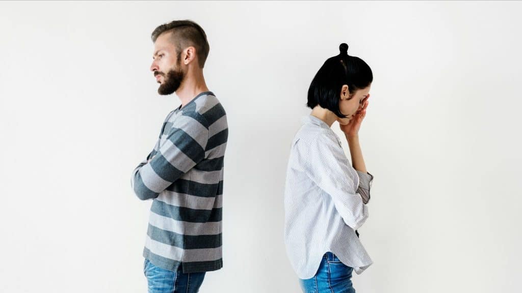 A man and woman turning each other’s back