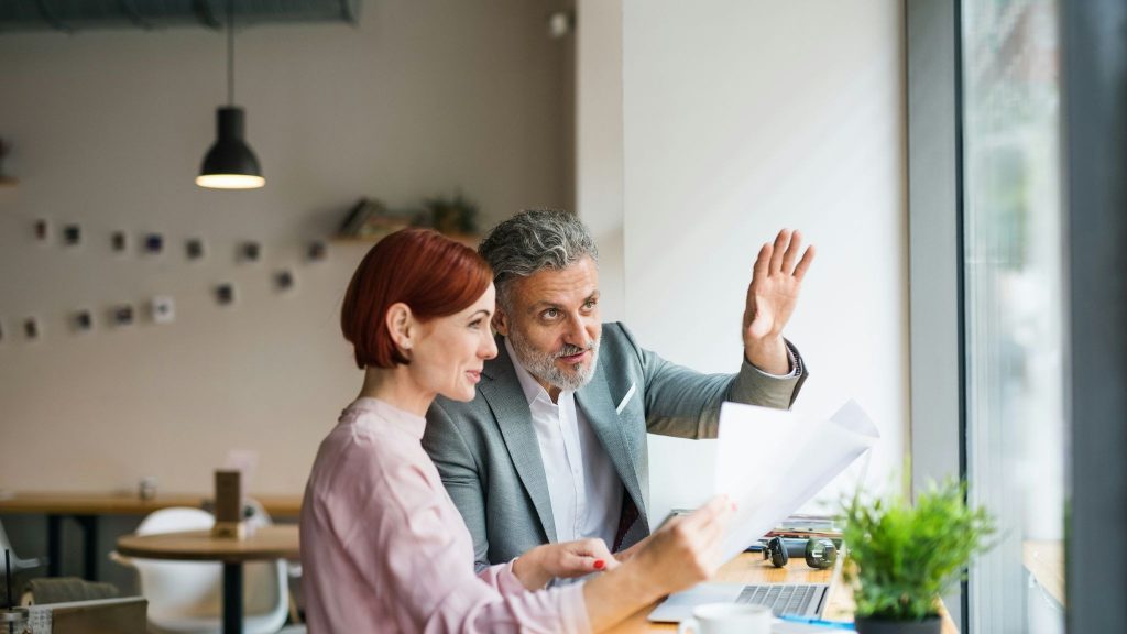 A man explaining something to woman