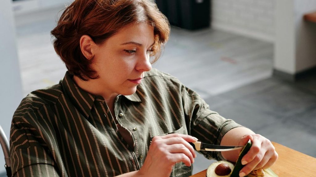 A woman cutting an avocado