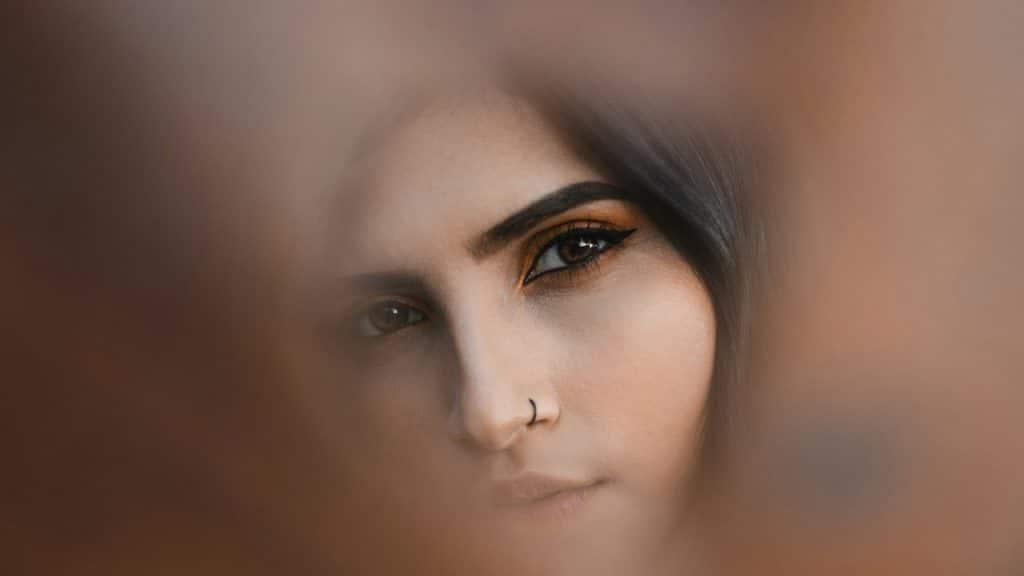 A woman staring out of a hole.